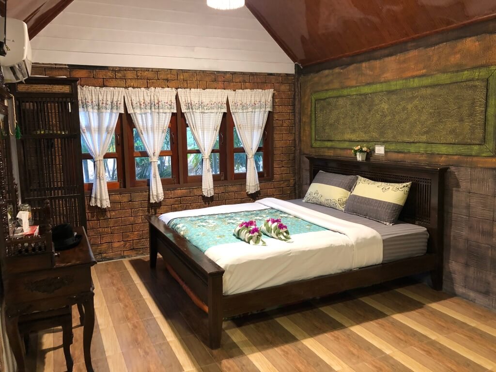 A pretty bed inside one of the bungalows at Banraigarden Home